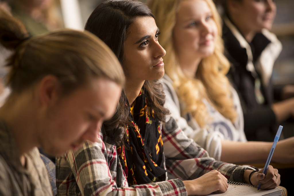 Group of students in class listening to instructor